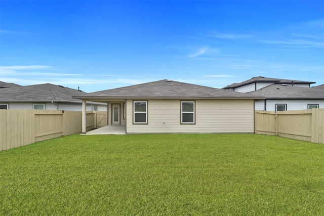 back of house featuring a yard and a patio