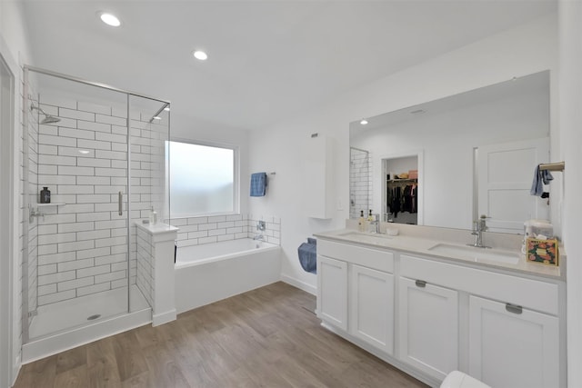 bathroom with vanity, hardwood / wood-style flooring, and separate shower and tub