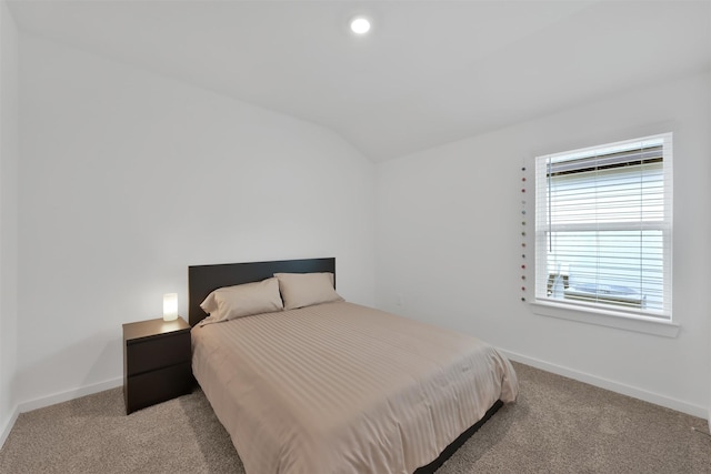 bedroom featuring lofted ceiling and light carpet