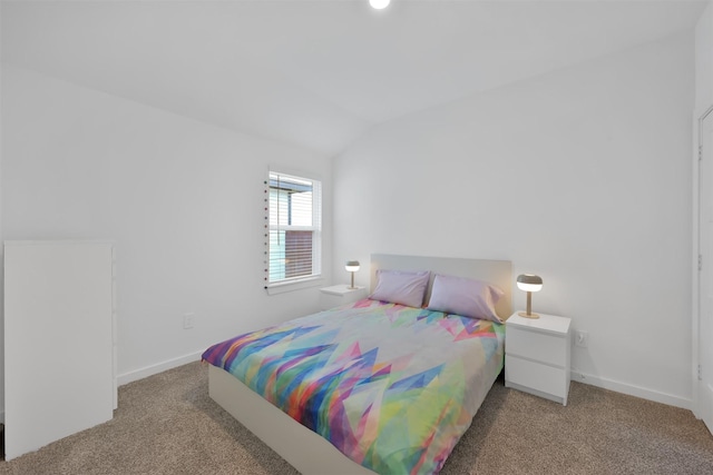 bedroom featuring carpet and vaulted ceiling