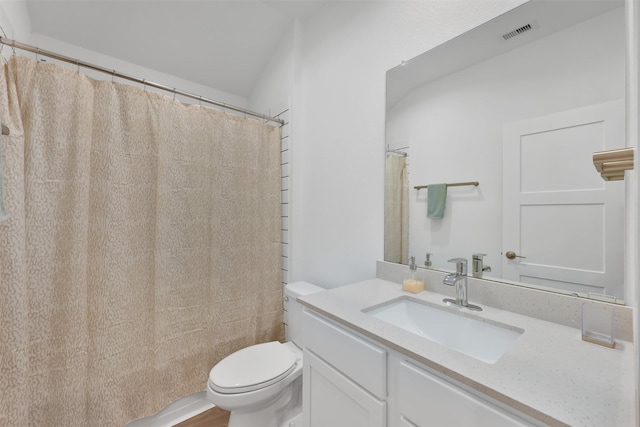 bathroom with hardwood / wood-style floors, vanity, toilet, and walk in shower