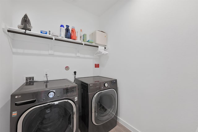 laundry room featuring wood-type flooring and independent washer and dryer