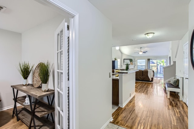 corridor with hardwood / wood-style flooring