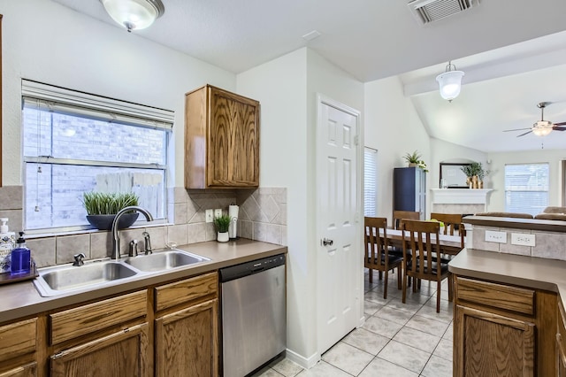 kitchen featuring decorative backsplash, stainless steel dishwasher, vaulted ceiling, ceiling fan, and sink