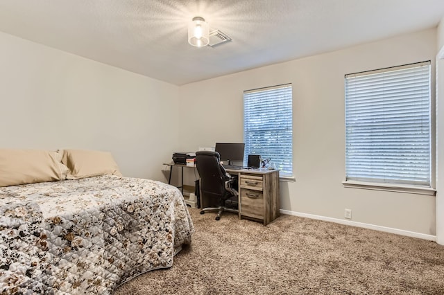 carpeted bedroom featuring a textured ceiling