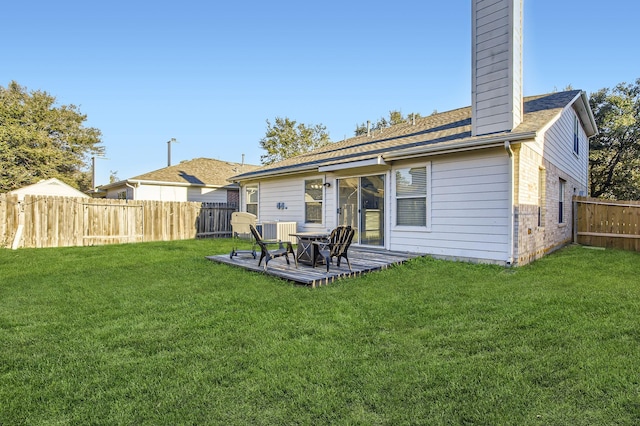 rear view of property with cooling unit and a lawn