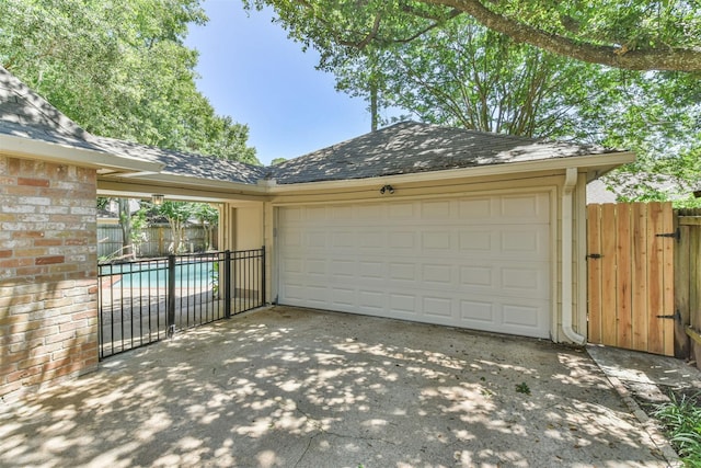 garage featuring a fenced in pool