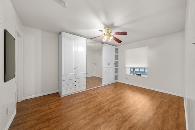 unfurnished bedroom featuring hardwood / wood-style flooring and ceiling fan