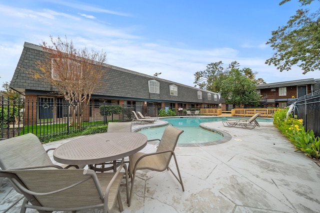 view of swimming pool with a patio area