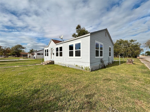 view of side of home with a yard