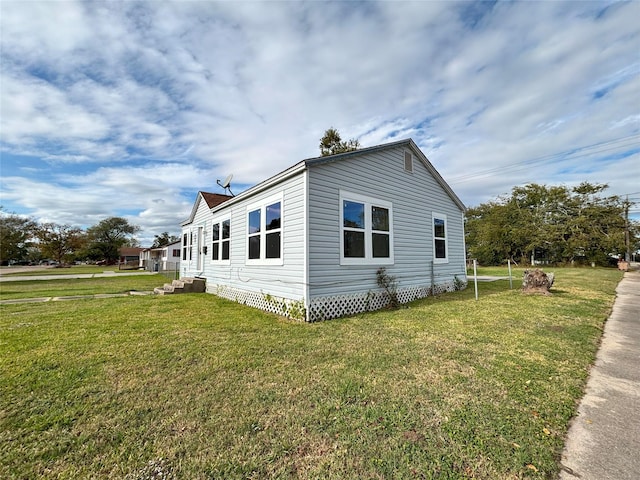 view of home's exterior with a yard