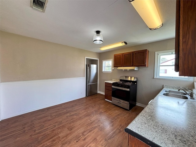 kitchen with sink, stainless steel appliances, and dark hardwood / wood-style floors