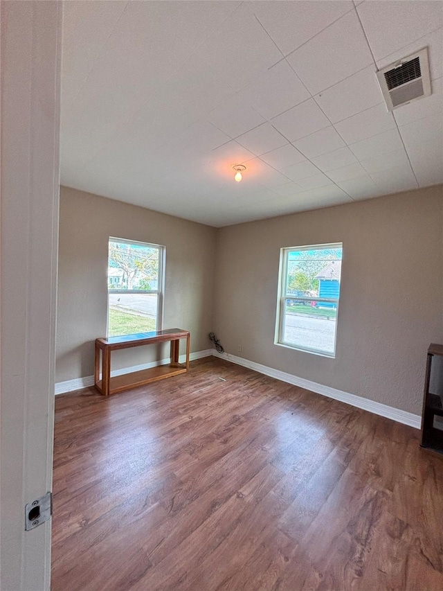 unfurnished room featuring hardwood / wood-style flooring