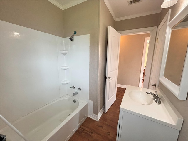 bathroom featuring washtub / shower combination, hardwood / wood-style floors, vanity, and crown molding