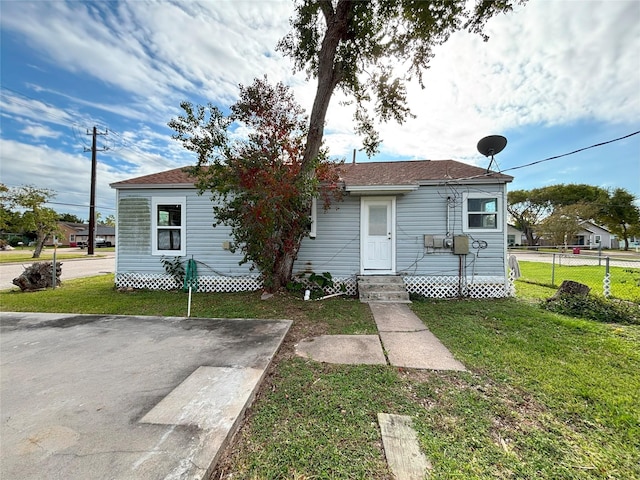 bungalow-style home with a front lawn