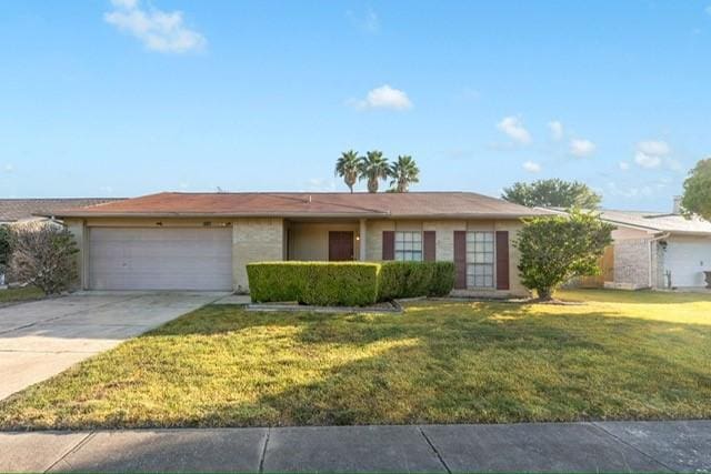 ranch-style house featuring a front yard and a garage