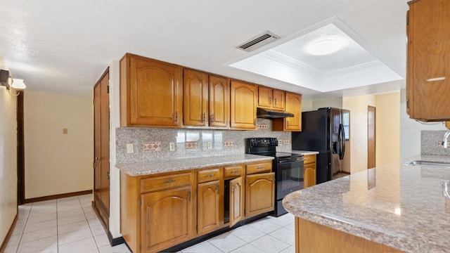 kitchen with black appliances, decorative backsplash, light stone counters, and light tile patterned floors