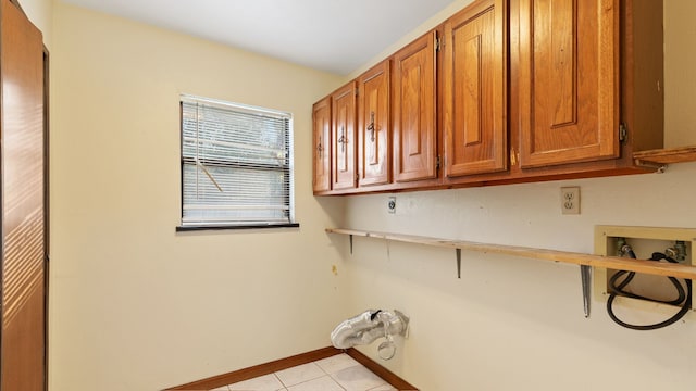 washroom featuring electric dryer hookup, light tile patterned flooring, cabinets, and hookup for a washing machine