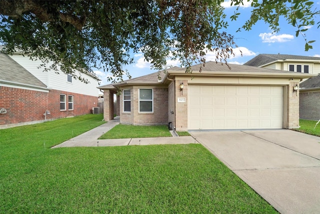 view of front facade with a garage, a front yard, and central AC