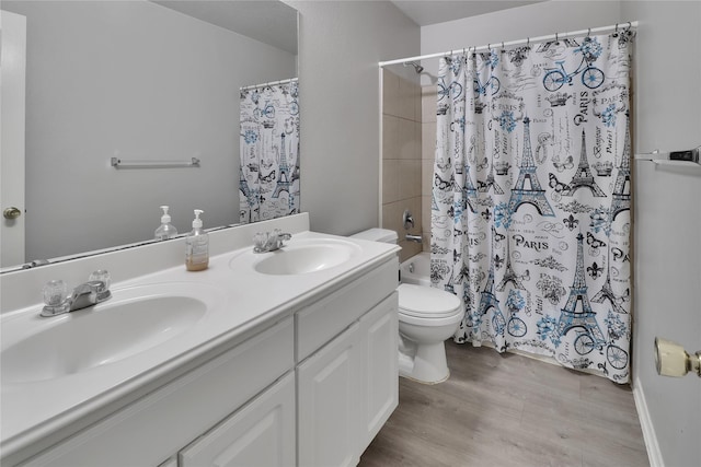 full bathroom with hardwood / wood-style flooring, vanity, toilet, and shower / tub combo with curtain