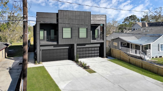 view of front of home featuring a garage and a balcony