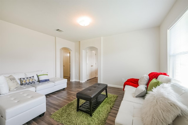 living room with dark hardwood / wood-style flooring