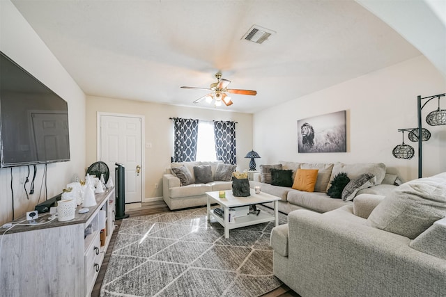 living room featuring hardwood / wood-style floors and ceiling fan