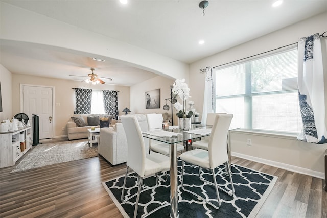 dining area featuring a wealth of natural light, ceiling fan, and dark hardwood / wood-style flooring