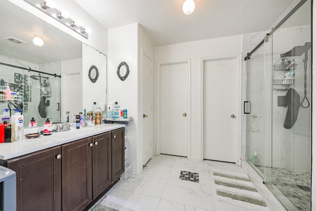 bathroom with vanity and a shower with shower door