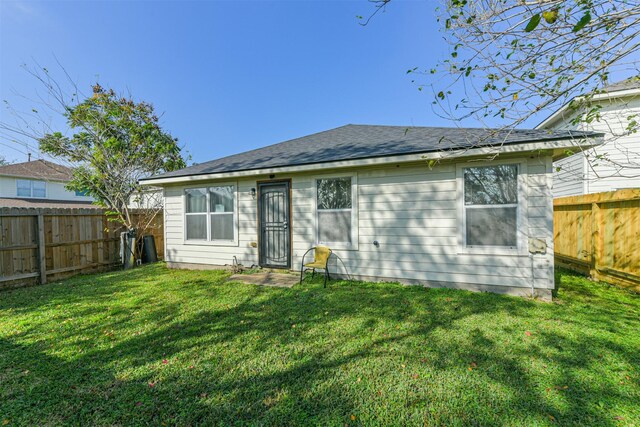 back of property featuring a yard