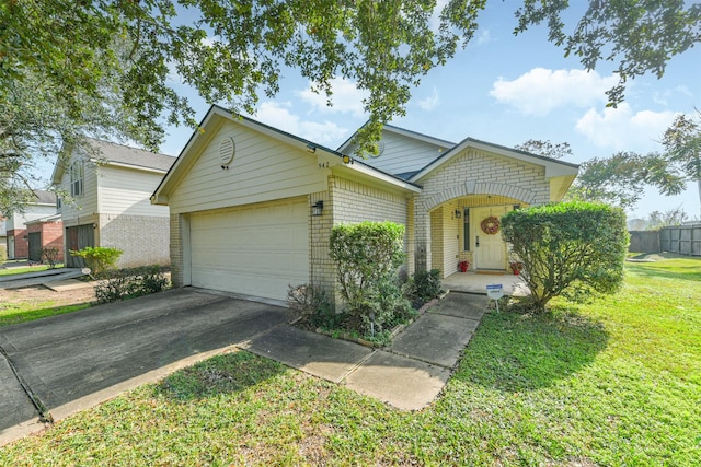 view of front of property featuring a front lawn and a garage