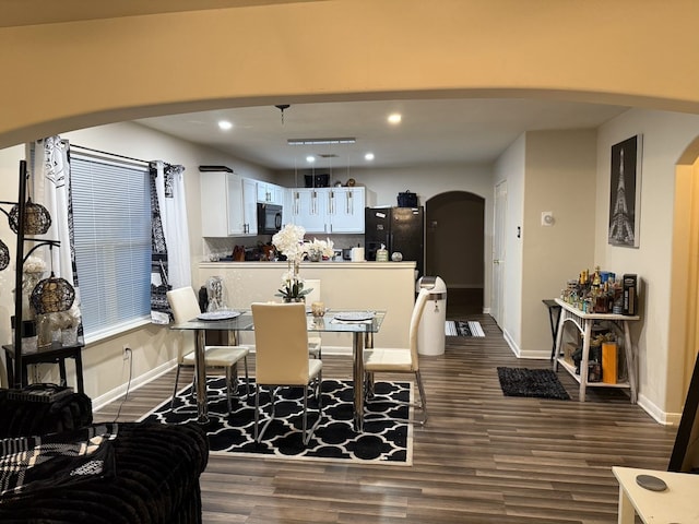 dining space with dark hardwood / wood-style floors