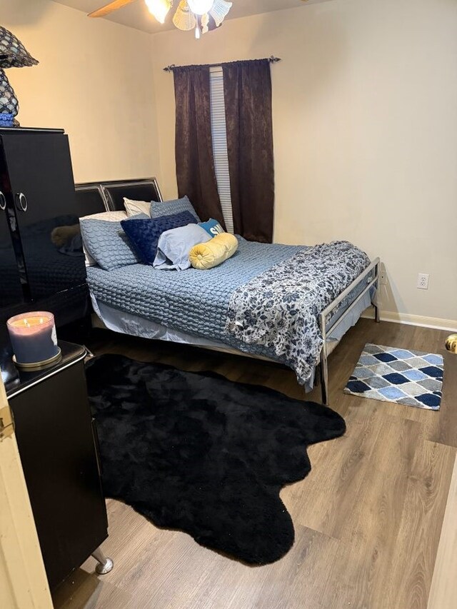 bedroom featuring ceiling fan and hardwood / wood-style floors