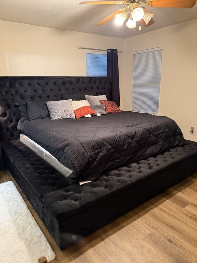 bedroom with ceiling fan and light hardwood / wood-style flooring