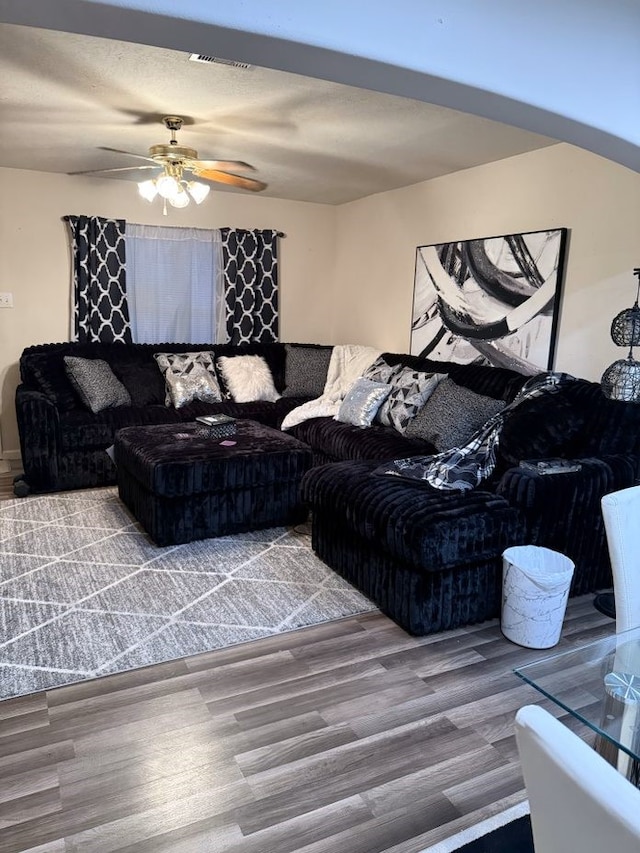 living room with ceiling fan and hardwood / wood-style flooring