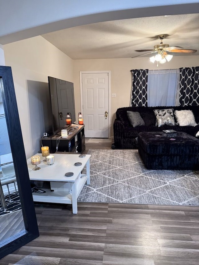 living room featuring hardwood / wood-style flooring and ceiling fan