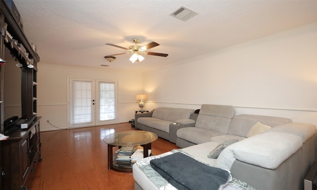 living room featuring french doors, a textured ceiling, ceiling fan, crown molding, and wood-type flooring