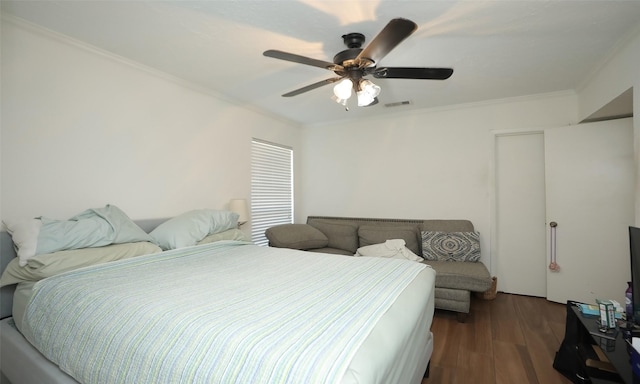 bedroom featuring dark hardwood / wood-style flooring, ceiling fan, and crown molding