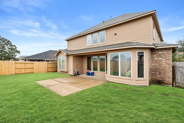 rear view of property with a lawn and a patio area