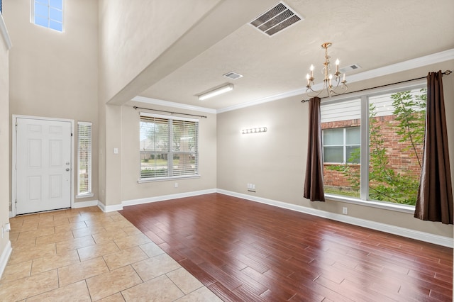 entryway featuring a chandelier and crown molding