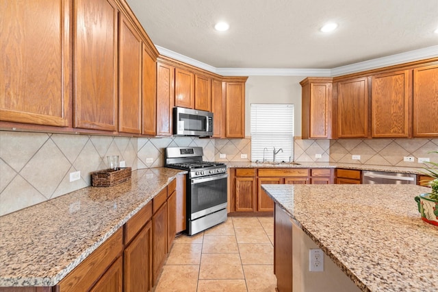 kitchen with light stone counters, stainless steel appliances, light tile patterned floors, decorative backsplash, and crown molding