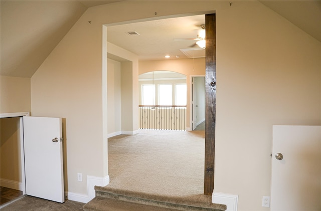 interior space featuring vaulted ceiling and carpet