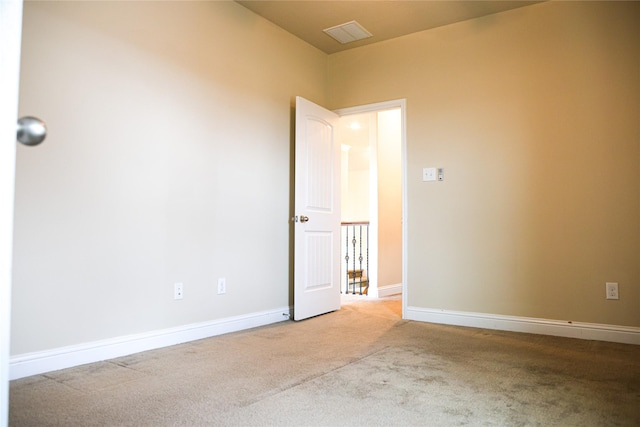 unfurnished room featuring light carpet