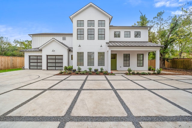 modern inspired farmhouse with a porch and a garage