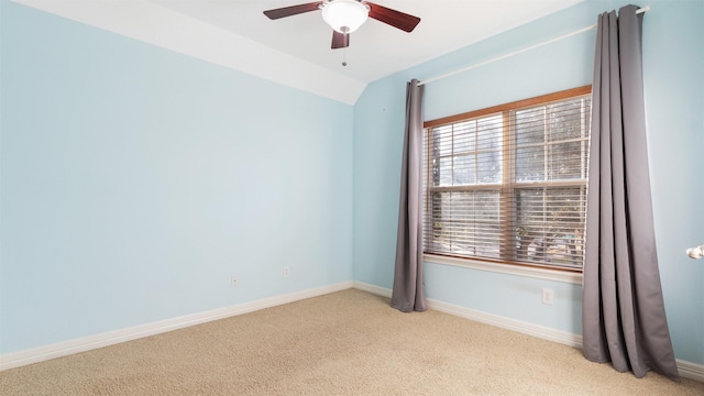 empty room with light colored carpet, ceiling fan, and lofted ceiling