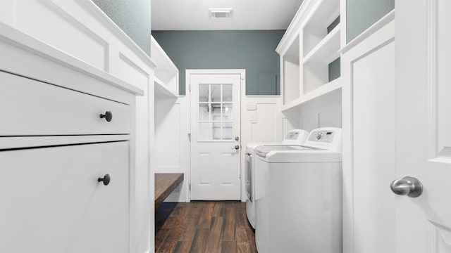 laundry area with dark hardwood / wood-style flooring and washing machine and dryer