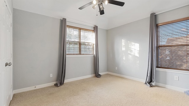 empty room featuring ceiling fan and light colored carpet