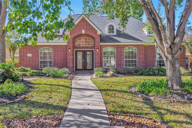 view of front facade featuring a front yard and french doors