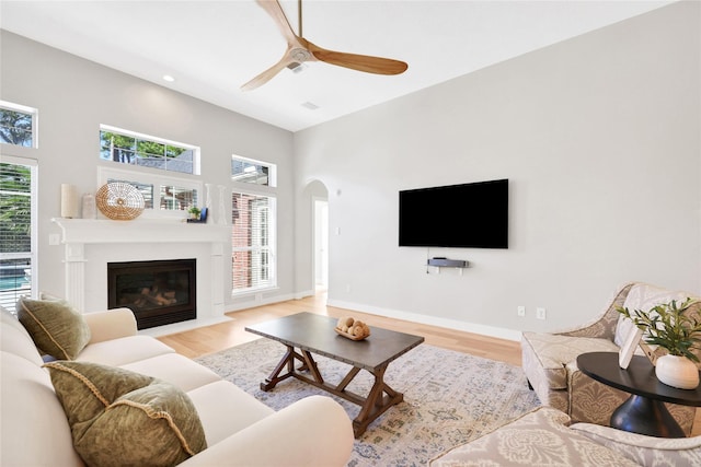 living room featuring ceiling fan, a healthy amount of sunlight, and light hardwood / wood-style floors