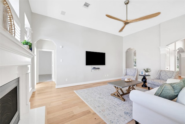 living room featuring ceiling fan and wood-type flooring